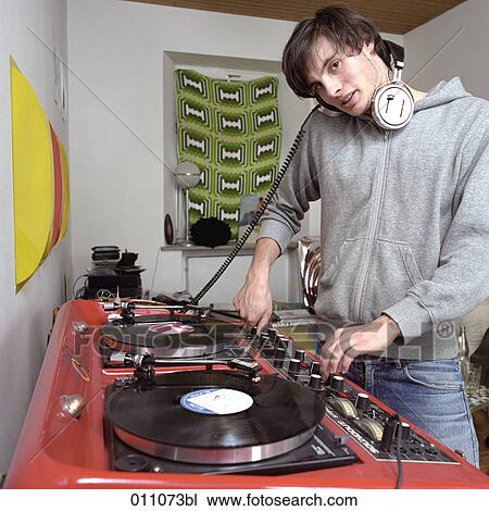 Young man at professional record player View Large Photo Image Stock Image - Young man at professional record player. Fotosearch