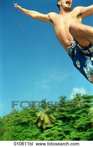 young man doing a high jump on the beach View Large Photo Image Stock Image - young man doing a high jump on the beach. Fotosearch