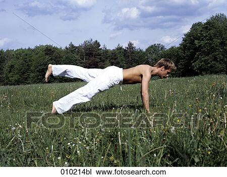 young man doing wellness training in the park View Large Photo Image Stock Image - young man doing wellness training in the park. Fotosearch