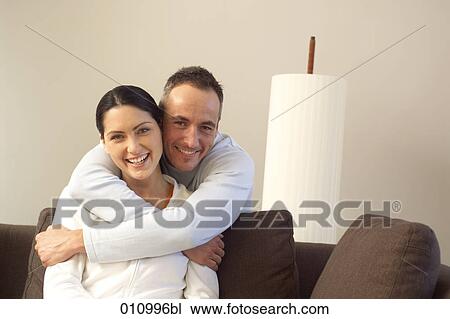 Young man embracing woman from behind View Large Photo Image Stock Image - Young man embracing woman from behind. Fotosearch