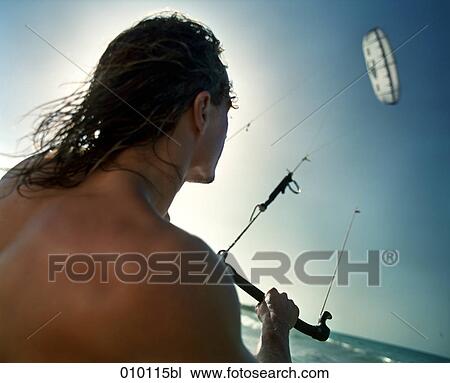 young man flying kite on the beach View Large Photo Image Stock Image - young man flying kite on the beach. Fotosearch