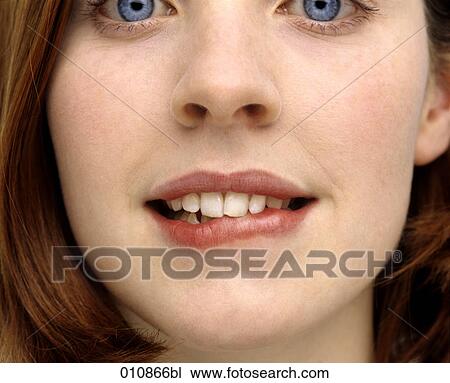 Young woman biting her lip View Large Photo Image Stock Image - Young woman biting her lip. Fotosearch