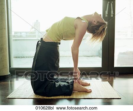 young woman doing yoga exercise on strawmat View Large Photo Image Stock Image - young woman doing yoga exercise on strawmat. Fotosearch