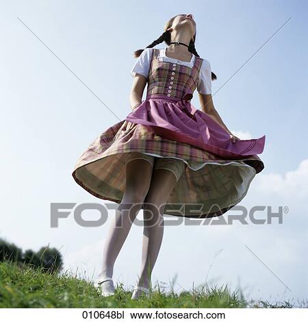 young woman in Bavarian dress dancing with lifted skirt View Large Photo Image Stock Image - young woman in Bavarian dress dancing with lifted skirt. Fotosearch