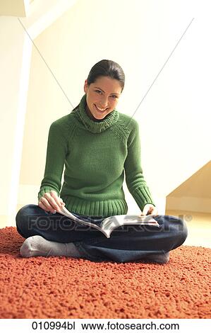 Young woman on red carpet caught while reading a magazine View Large Photo Image Stock Image - Young woman on red carpet caught while reading a magazine. Fotosearch