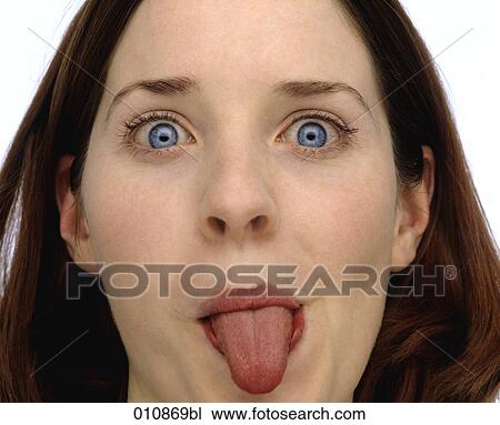 Stock Image - Young woman showing her tongue. Fotosearch