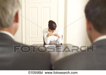 young woman sitting at a conference table with two businessmen in the foreground View Large Photo Image Stock Image - young woman sitting at a conference table with two businessmen in the foreground. Fotosearch