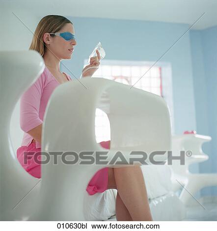 young woman sitting in stylish ambience wearing a gelmask over the eyes View Large Photo Image Stock Image - young woman sitting in stylish ambience wearing a gelmask over the eyes. Fotosearch