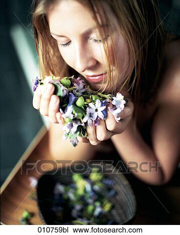 young woman taking a smell at different flower petals View Large Photo Image Stock Image - young woman taking a smell at different flower petals. Fotosearch