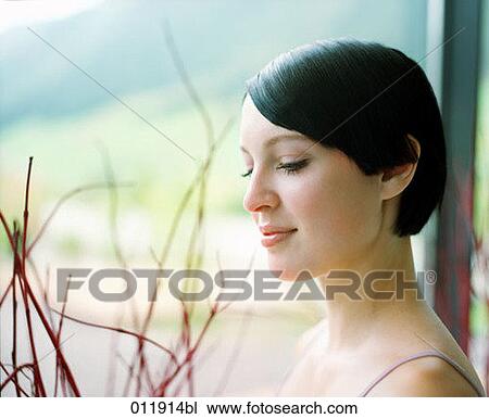 black haired young woman standing by the window View Large Photo Image Stock Image - black haired young woman standing by the window. Fotosearch
