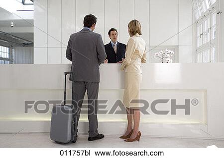 businessman and businesswoman being helped at reception View Large Photo Image Stock Image - businessman and businesswoman being helped at reception. Fotosearch