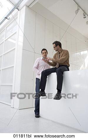 businessman giving explanation about his mobile to colleague View Large Photo Image Stock Image - businessman giving explanation about his mobile to colleague. Fotosearch