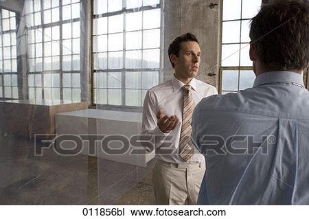 businessmen making a point to his partner in empty building View Large Photo Image Stock Image - businessmen making a point to his partner in empty building. Fotosearch