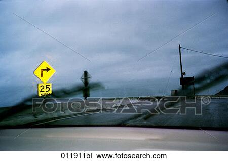 car driving through the rain on an empty road by the sea View Large Photo Image Stock Image - car driving through the rain on an empty road by the sea. Fotosearch