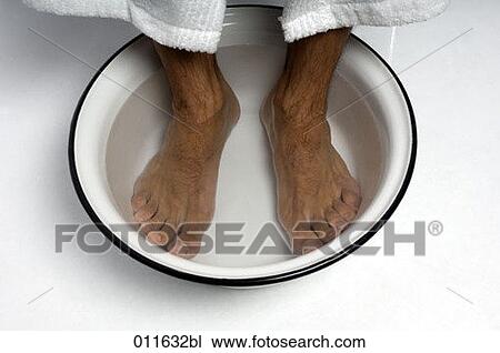 Stock Image - close-up of feet in a bowl of water. Fotosearch