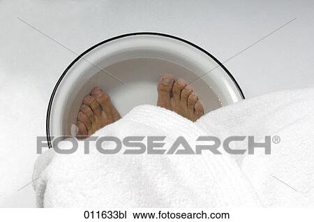 Stock Image - close-up of man taking a footbath. Fotosearch