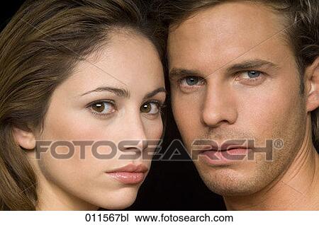 close-up of young couple looking into camera View Large Photo Image Stock Image - close-up of young couple looking into camera. Fotosearch