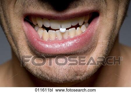 close up of young man´s mouth with tablet between teeth View Large Photo Image Stock Image - close up of young man´s mouth with tablet between teeth. Fotosearch