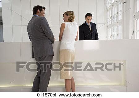 Stock Image - couple having a conversation at reception. Fotosearch