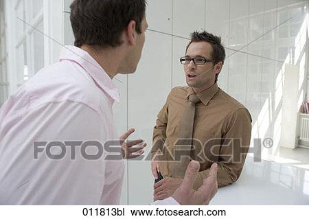 discussion between two office workers View Large Photo Image Stock Image - discussion between two office workers. Fotosearch