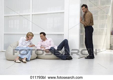 Stock Image - distrustful man listening to a conversation. Fotosearch