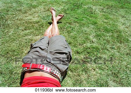 feet of young woman lying on grass View Large Photo Image Stock Image - feet of young woman lying on grass. Fotosearch