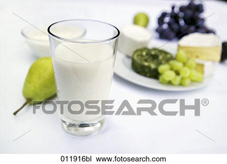 Stock Image - glass of milk and assortment of fruit and cheese. Fotosearch