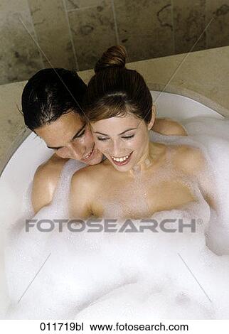 laughing couple sitting in bubble bath View Large Photo Image Stock Image - laughing couple sitting in bubble bath. Fotosearch