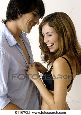 laughing young woman unbottoning her friend´s shirt View Large Photo Image Stock Image - laughing young woman unbottoning her friend´s shirt. Fotosearch