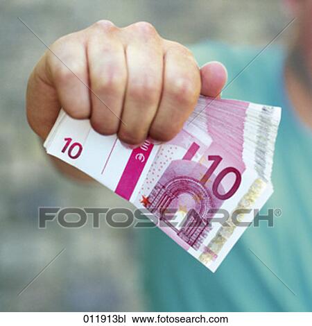 man holding bundle of ten Euro notes in his fist View Large Photo Image Stock Image - man holding bundle of ten Euro notes in his fist. Fotosearch
