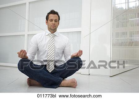 Stock Image - man in shirt and tie meditating. Fotosearch