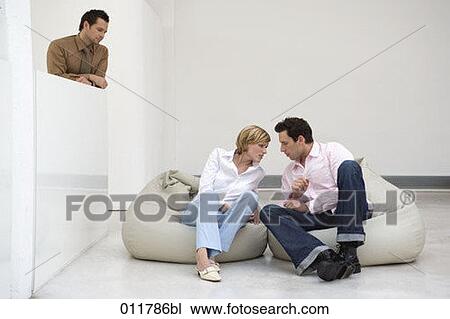 man watching young couple whispering to each other View Large Photo Image Stock Image - man watching young couple whispering to each other. Fotosearch