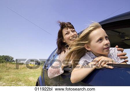 Stock Image - mother and daughter sitting in car and looking out of the window. Fotosearch