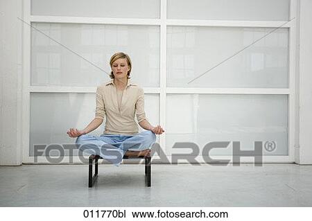 portrait of blonde woman sitting on stool and meditating View Large Photo Image Stock Image - portrait of blonde woman sitting on stool and meditating. Fotosearch