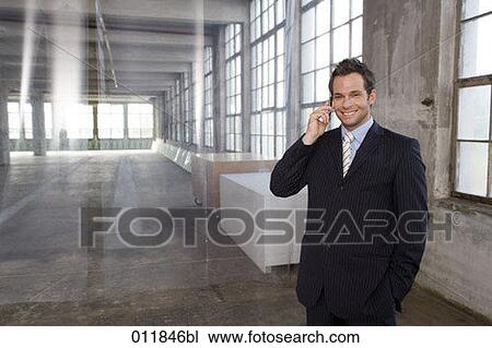 portrait of smiling businessman making a phone call in factory building View Large Photo Image Stock Image - portrait of smiling businessman making a phone call in factory building. Fotosearch