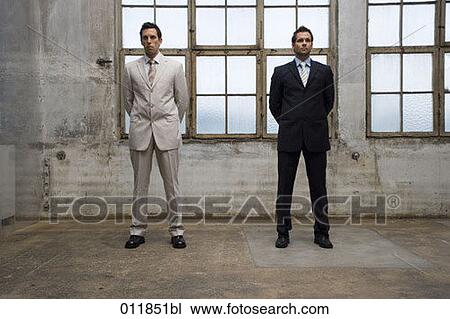 Stock Image - portrait of two businessmen standing side by side. Fotosearch