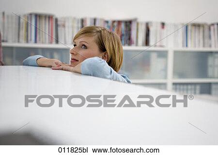 portrait of young woman leaning her head on a table View Large Photo Image Stock Image - portrait of young woman leaning her head on a table. Fotosearch