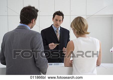 receptionist checking credit card View Large Photo Image Stock Image - receptionist checking credit card. Fotosearch