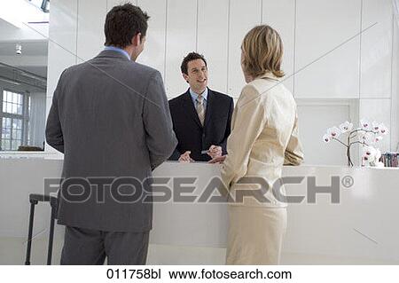 receptionist giving explanation to businessman and businesswoman View Large Photo Image Stock Image - receptionist giving explanation to businessman and businesswoman. Fotosearch