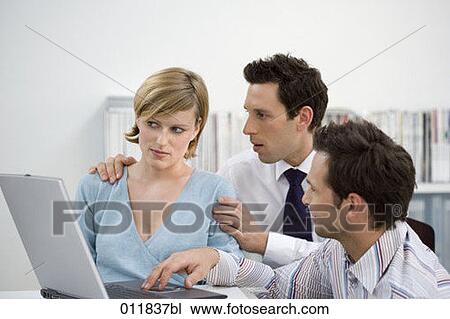 sceptical looking woman being helped by colleagues View Large Photo Image Stock Image - sceptical looking woman being helped by colleagues. Fotosearch