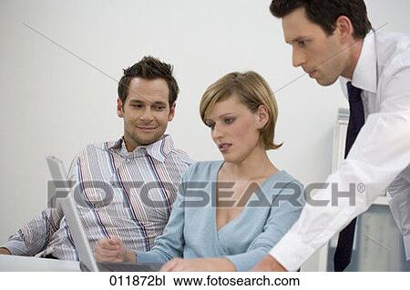 sceptical looking woman working with colleagues on laptop computer View Large Photo Image Stock Image - sceptical looking woman working with colleagues on laptop computer. Fotosearch