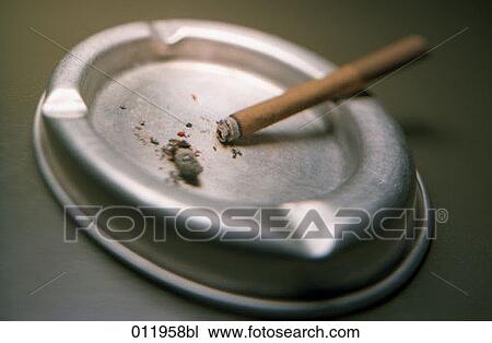 small cigar lying in silver ashtray View Large Photo Image Stock Image - small cigar lying in silver ashtray. Fotosearch