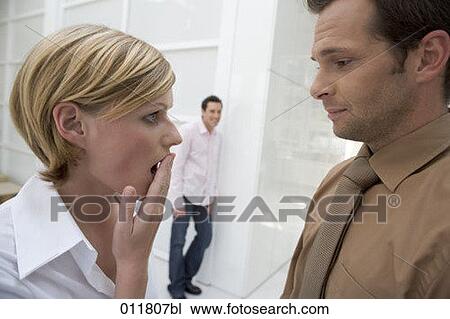 surprised looking woman having a conversation with male colleague in office environment View Large Photo Image Stock Image - surprised looking woman having a conversation with male colleague in office environment. Fotosearch