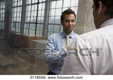 two businessmen having a discussion in empty factory building View Large Photo Image Stock Image - two businessmen having a discussion in empty factory building. Fotosearch