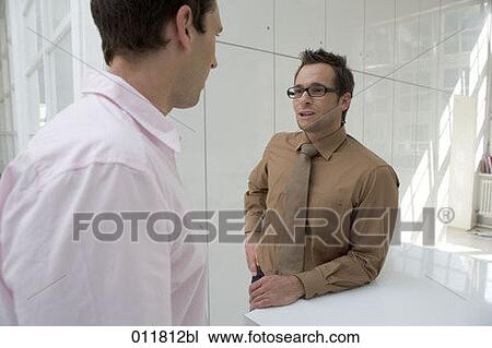two businessmen having a discussion View Large Photo Image Stock Image - two businessmen having a discussion. Fotosearch