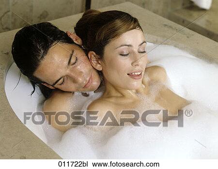 Stock Image - young couple relaxing in bath. Fotosearch