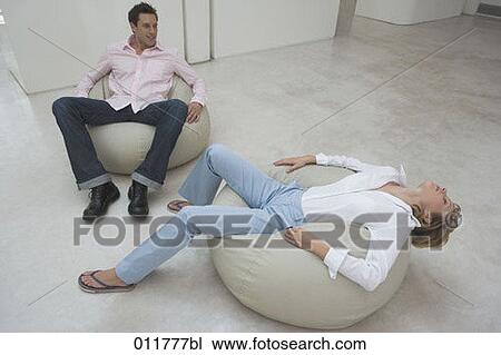 young couple relaxing on bean bags View Large Photo Image Stock Image - young couple relaxing on bean bags. Fotosearch