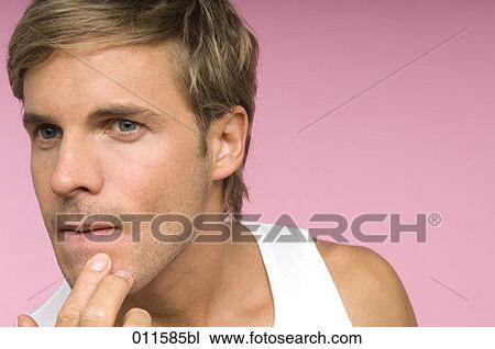 young man looking at himself in a mirror View Large Photo Image Stock Image - young man looking at himself in a mirror. Fotosearch