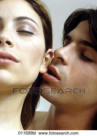 young man nibbling on a woman´s ear View Large Photo Image Stock Image - young man nibbling on a woman´s ear. Fotosearch
