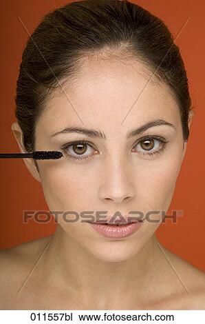 young woman applying some mascara View Large Photo Image Stock Image - young woman applying some mascara. Fotosearch